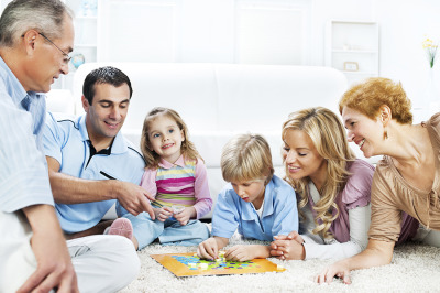 Cheerful Extended Family Playing Board Game On The Floor.